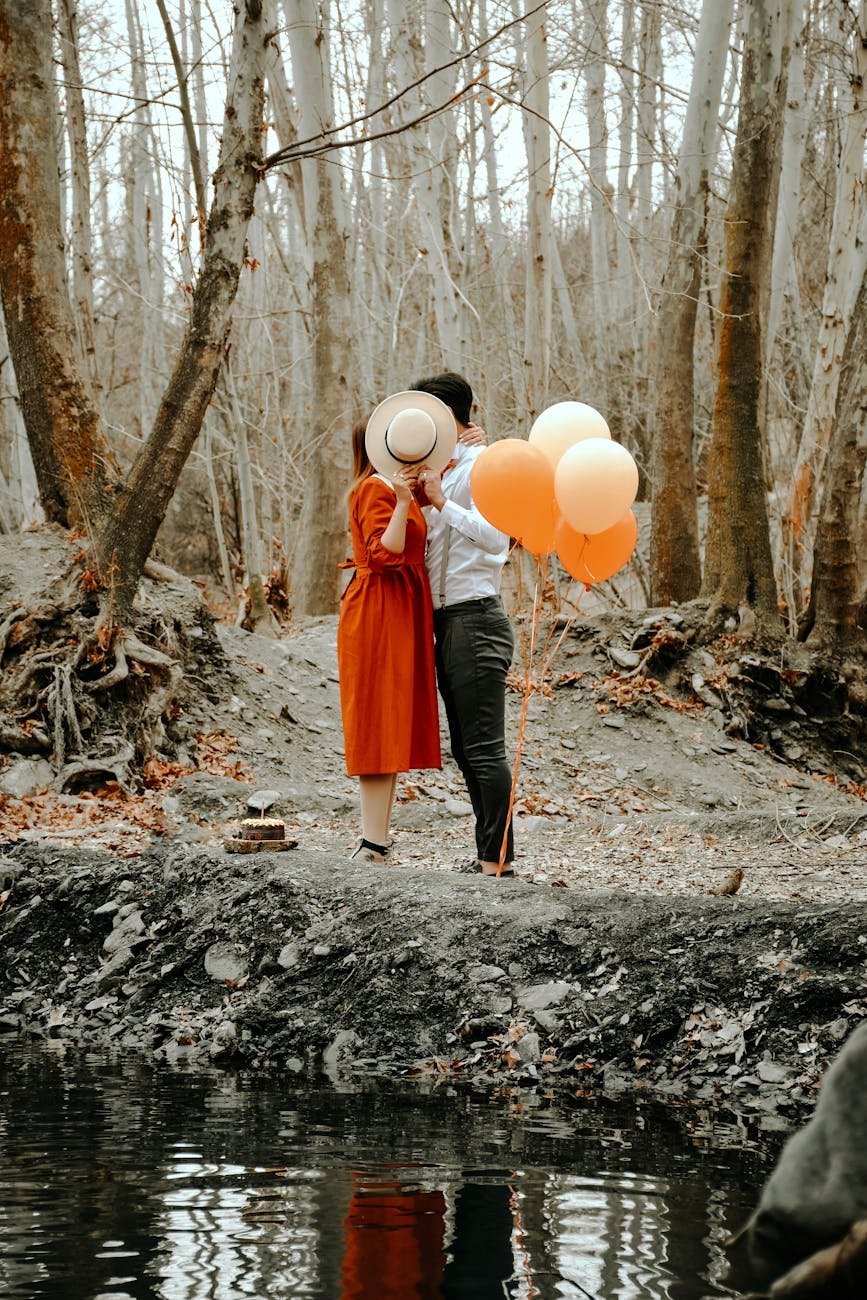 happy couple kissing in forest